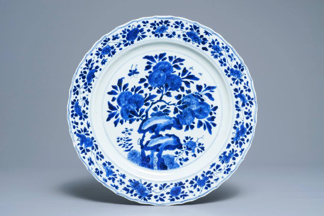 A Chinese blue and white dish with floral design,: A Chinese blue and white dish with floral design, Kangxi mark and of the period Dia.: 36,5 cm --------- Please request condition reports by e-mail on info@rm-auctions.com or by using the LiveAuctionee