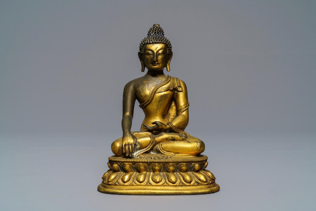 A Sino-Tibetan gilt bronze figure of Buddha Shakyamuni,: A Sino-Tibetan gilt bronze figure of Buddha Shakyamuni, 17/18th C. ----- H.: 15,8 cm Provenance: The private collection of a deceased Belgian antiques dealer.