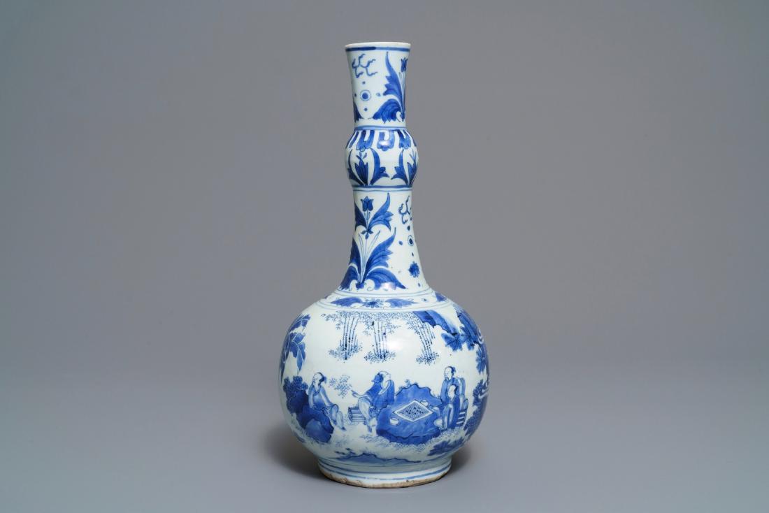 A Chinese blue and white bottle vase with figures in a: A Chinese blue and white bottle vase with figures in a landscape, Transitional period ----- H.: 38,5 cm