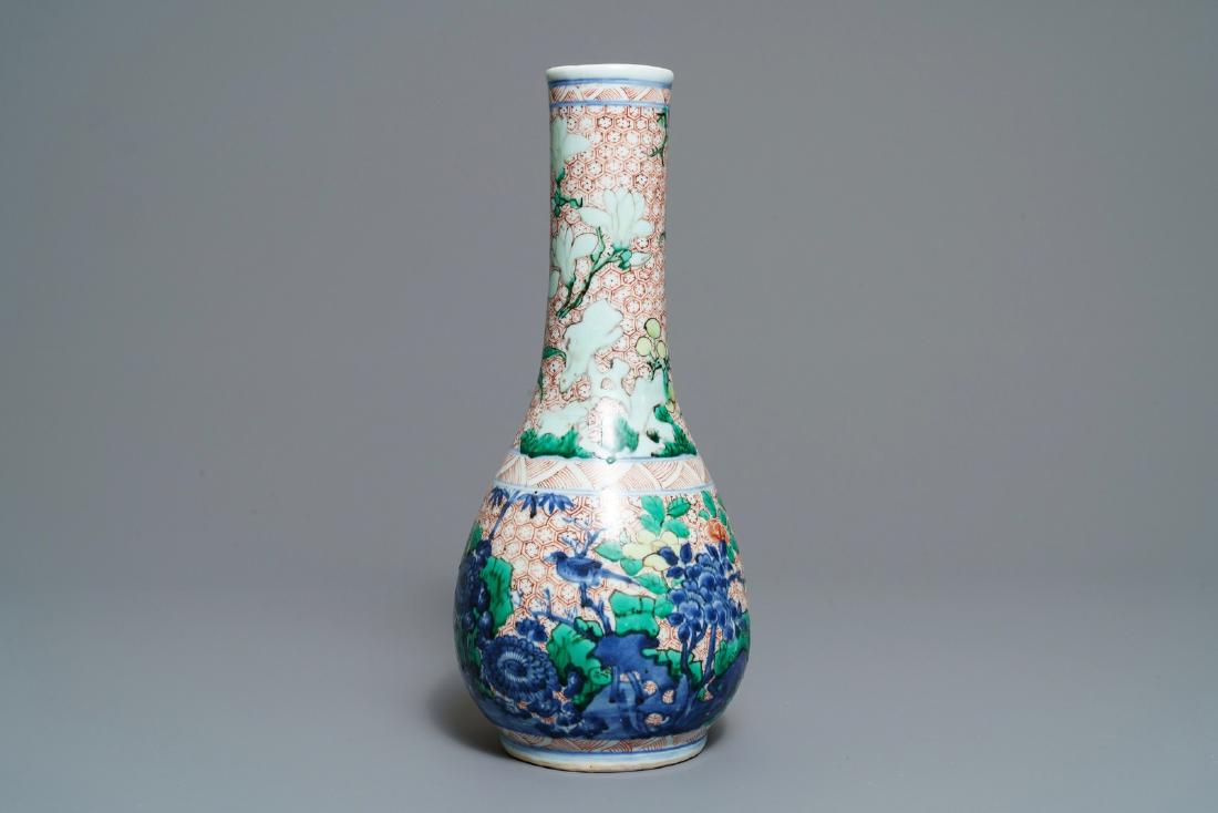 A Chinese wucai bottle vase with birds in a garden,: A Chinese wucai bottle vase with birds in a garden, Transitional period ----- H.: 38 cm Provenance: The Morpurgo collection, Amsterdam, The Netherlands.