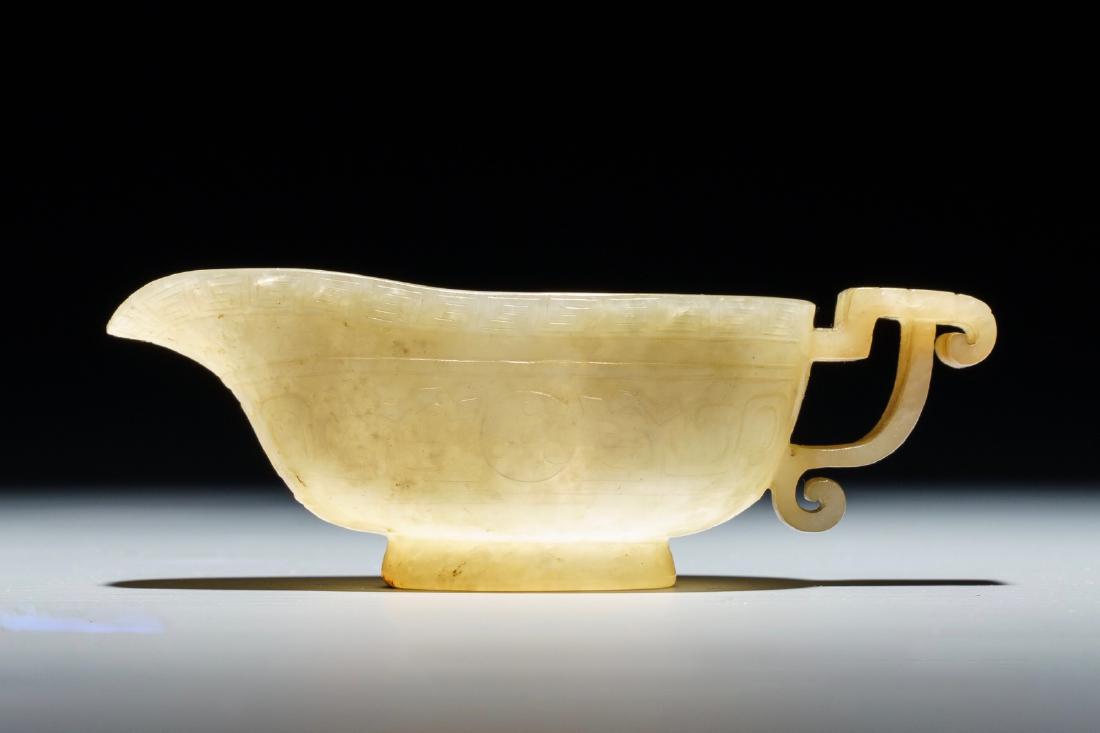 A Chinese pale yellow jade libation cup, 19th C.: A Chinese pale yellow jade libation cup, 19th C. ---- Dim.: 9 x 4 x 3 cm