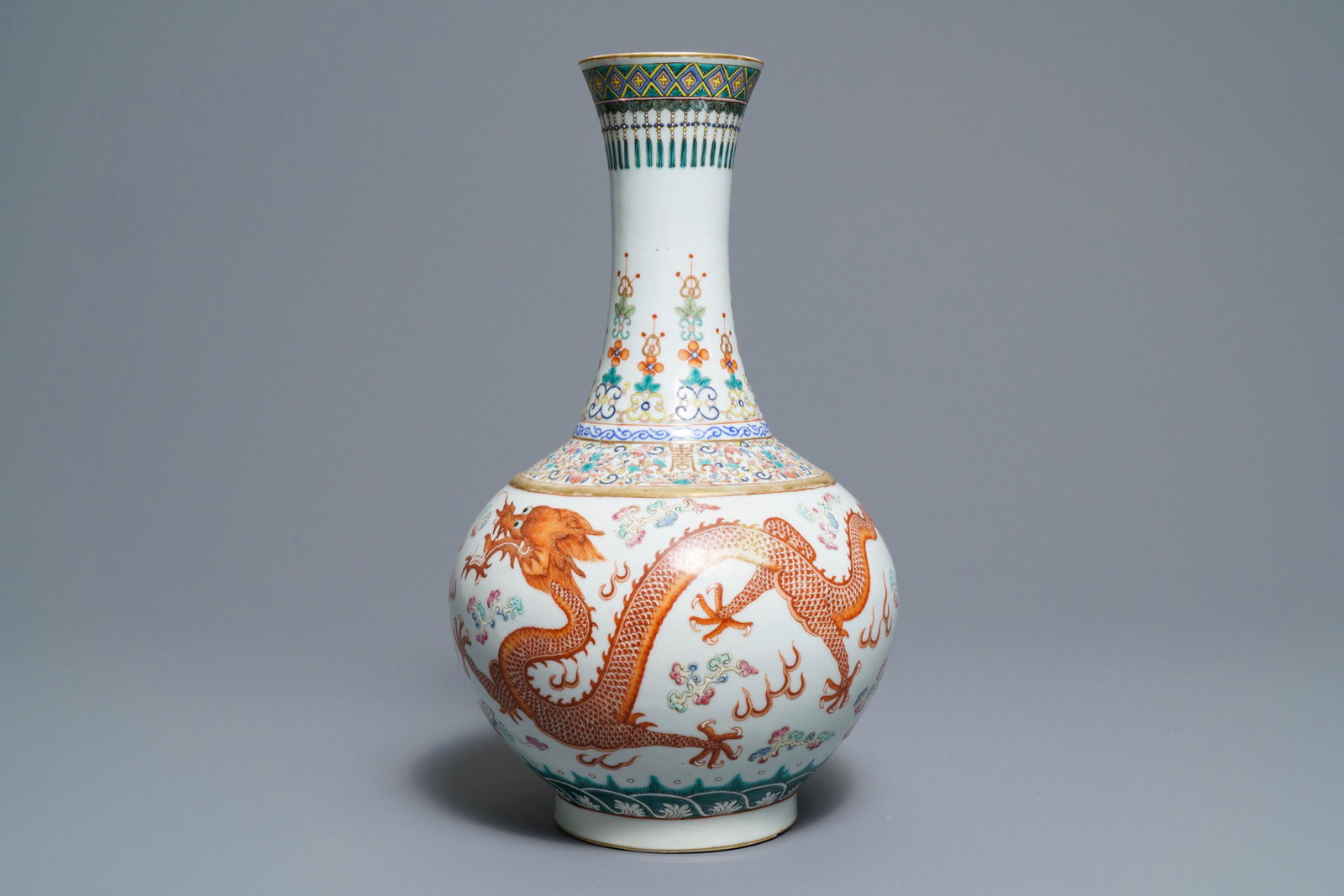 A Chinese famille rose 'dragon and phoenix' bottle: A Chinese famille rose 'dragon and phoenix' bottle vase, Guangxu mark and of the period -- H.: 40,5 cmÂ Condition: (UV-checked) - In excellent condition. Minor superficial wear to the iron red and 