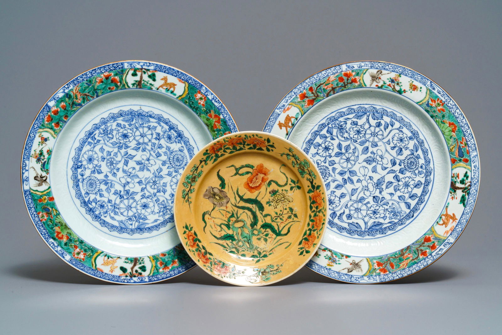 Three Chinese famille verte dishes, Kangxi: A pair of Chinese famille verte dishes and a café au lait-ground plate, Kangxi Dia.: 30 cm (the pair of dishes) Dia.: 20,5 cm (the plate)