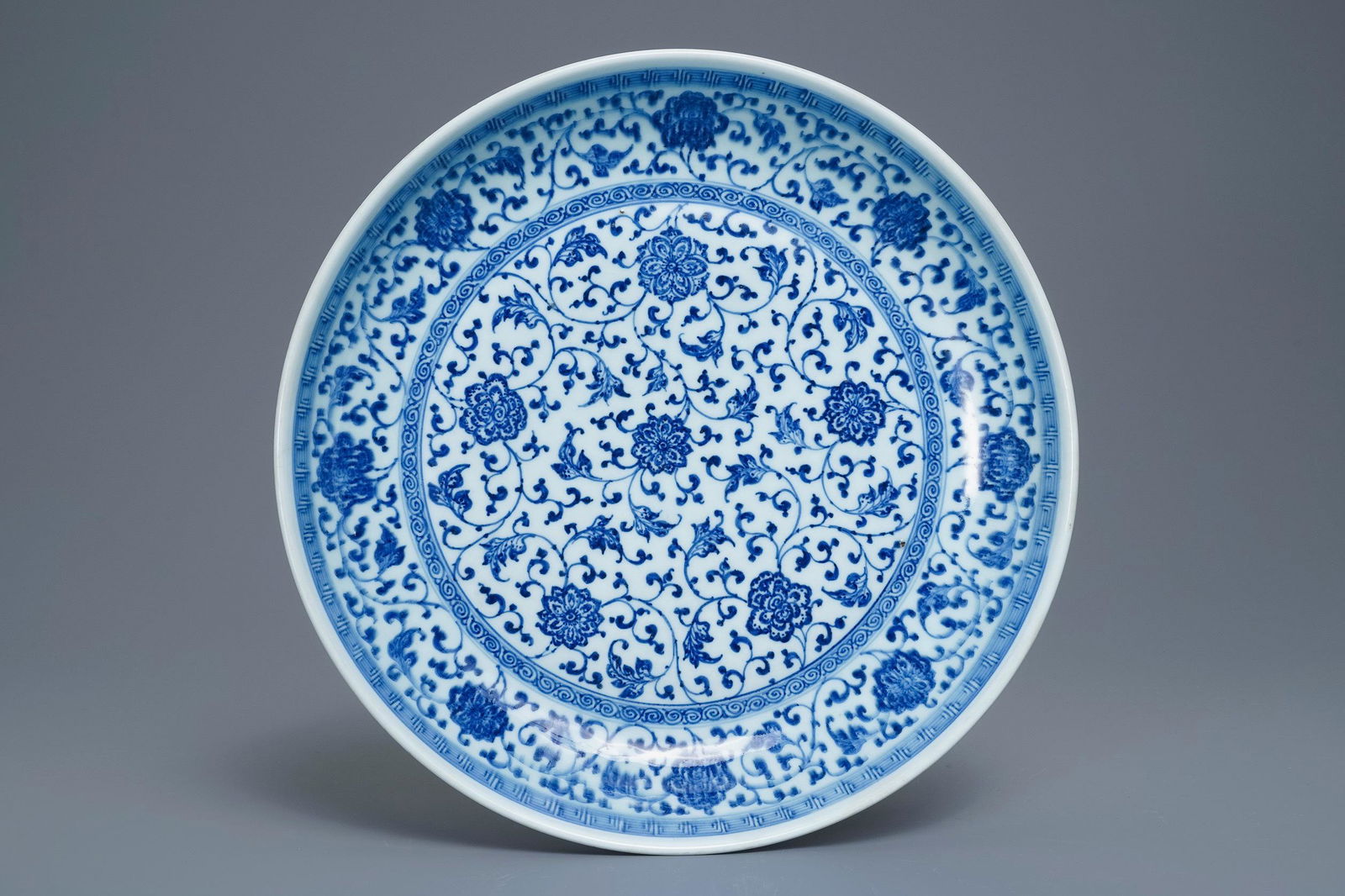A Chinese Ming-style blue and white 'floral scroll': A Chinese Ming-style blue and white 'floral scroll' dish, Qianlong -- Dia.: 34 cm
