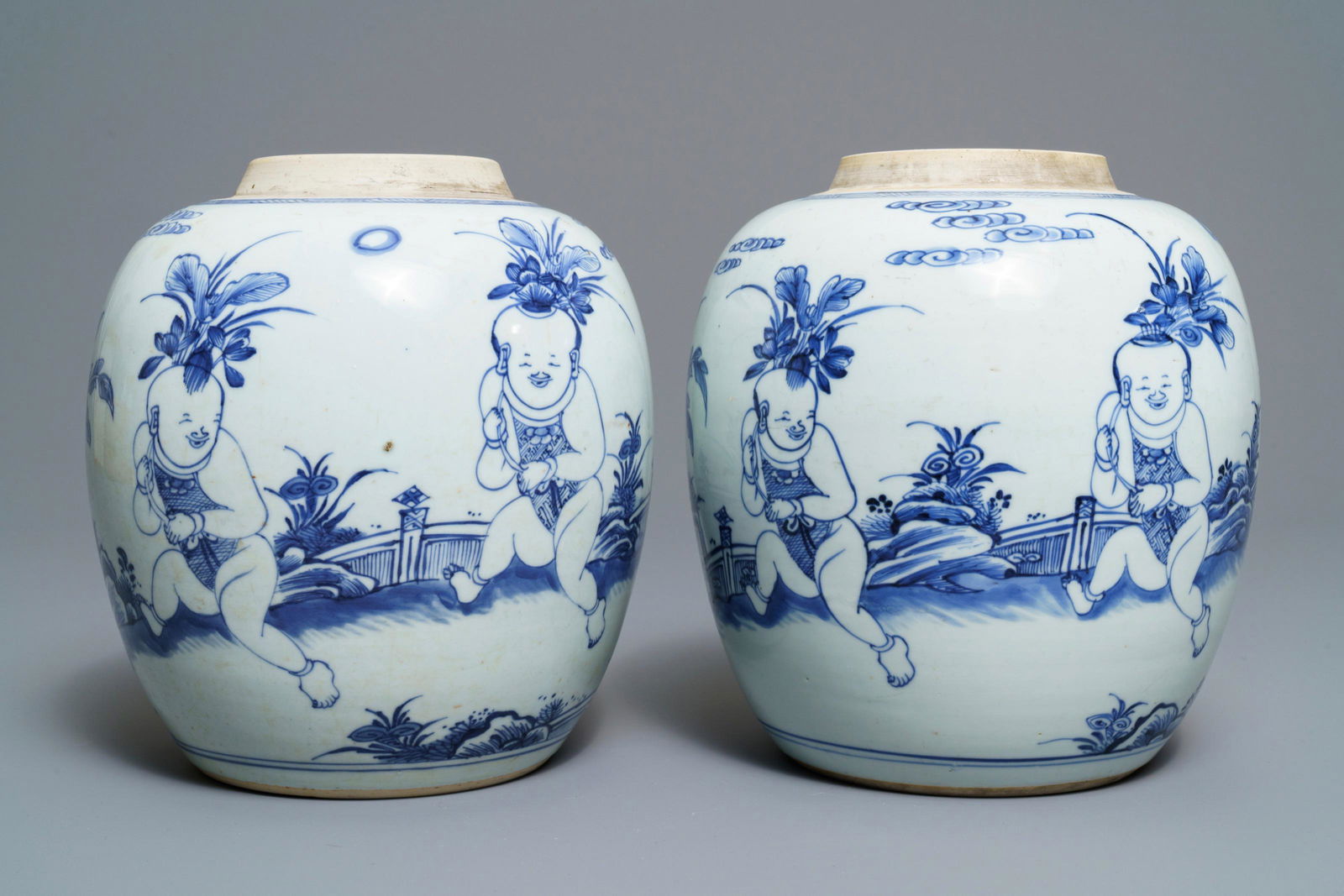 A pair of Chinese blue and white jars with boys in a: A pair of Chinese blue and white jars with boys in a garden, Kangxi -- H.: 22 cmÂ Condition: (UV-checked) - One in excellent condition. Two ca. 3 cm star-shaped glaze lines visible on the inside, i