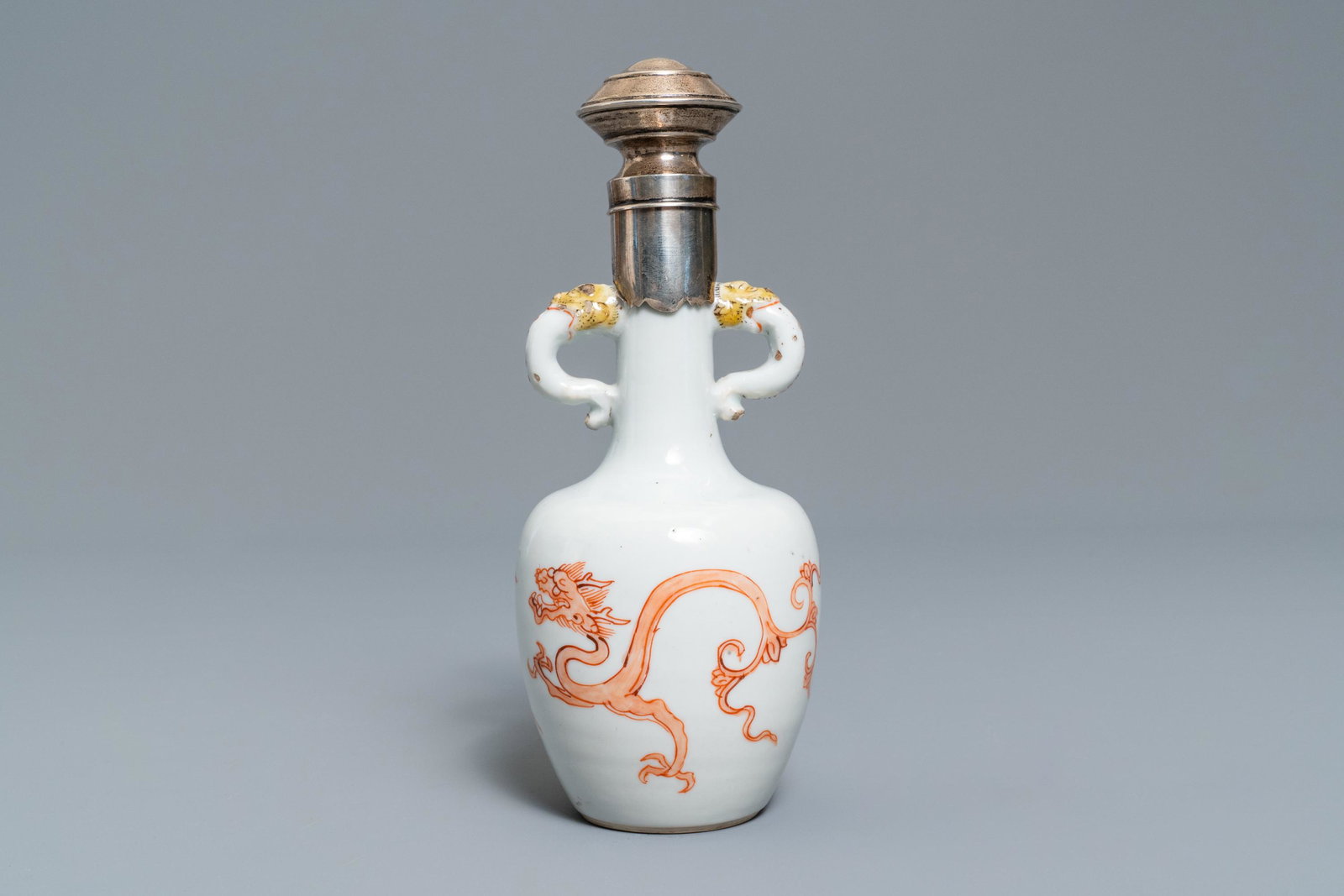 A Chinese silver-mounted iron red 'dragon and phoenix': A Chinese silver-mounted iron red 'dragon and phoenix' vase, Kangxi H.: 18,5 cmÂ