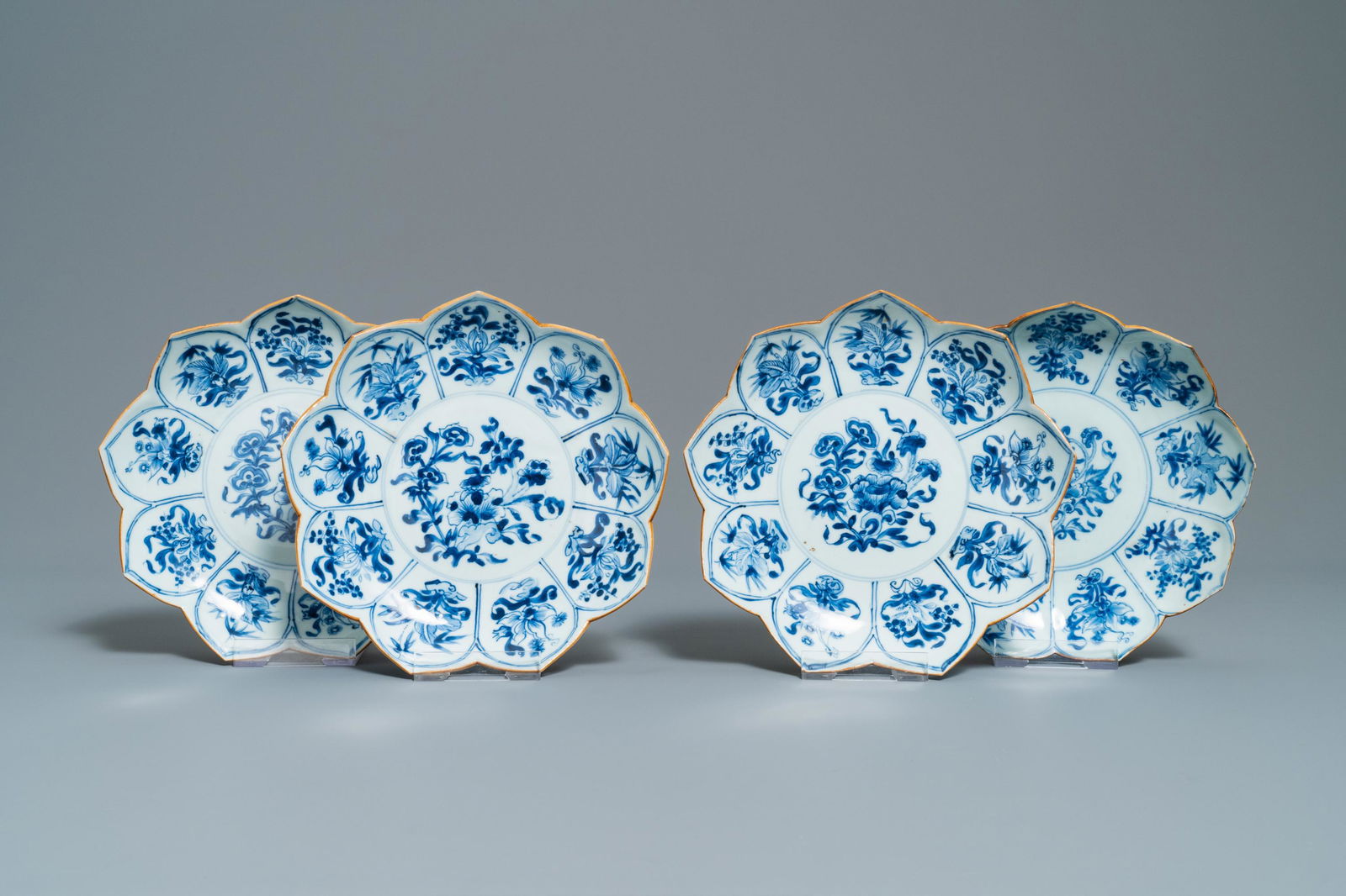 Four Chinese blue and white lotus-shaped plates with: Four Chinese blue and white lotus-shaped plates with floral design, Kangxi Dia.: 22,5 cm