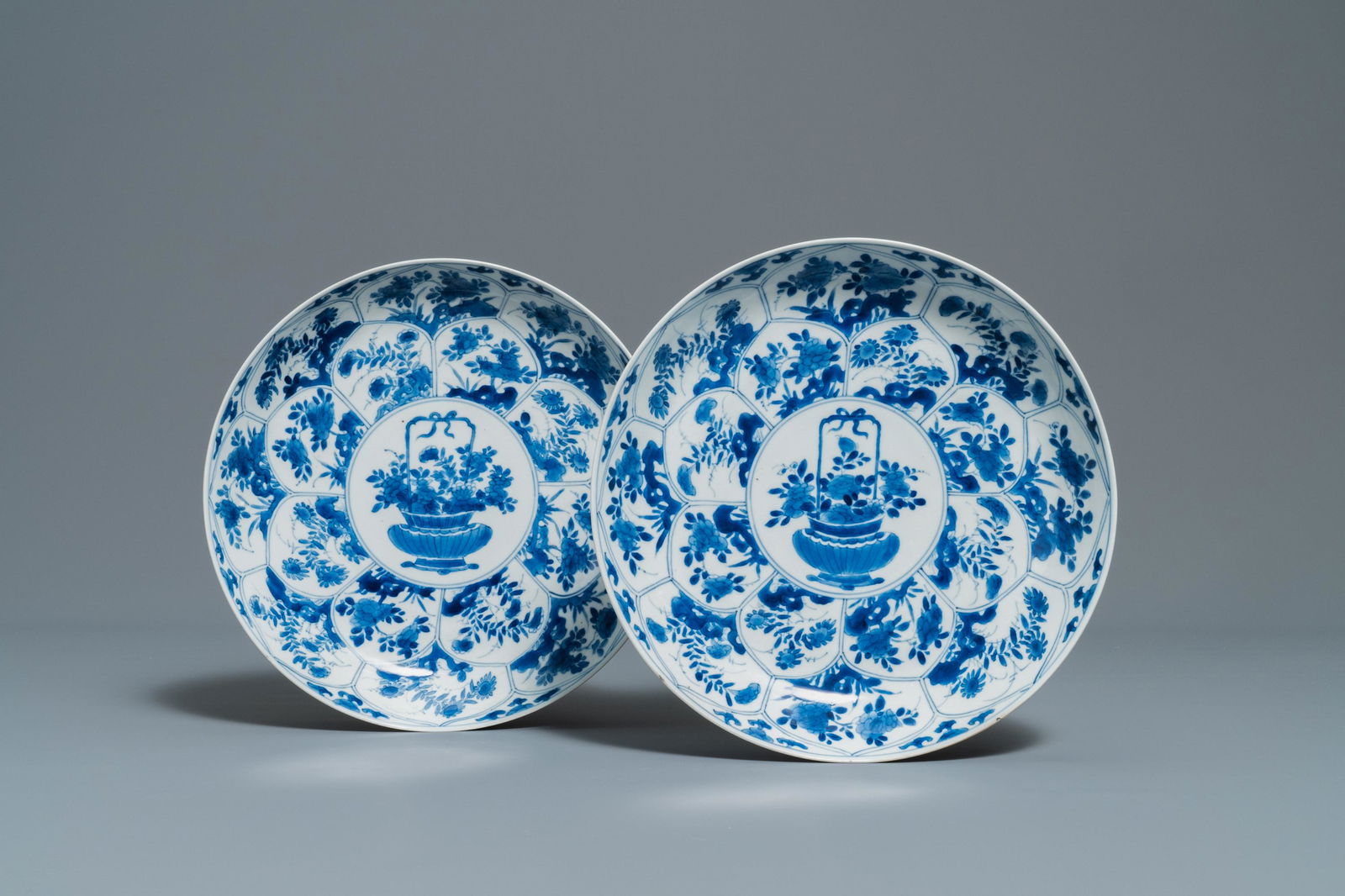 A pair of Chinese blue and white 'flower basket': A pair of Chinese blue and white 'flower basket' dishes, Kangxi Dia.: 27 cm