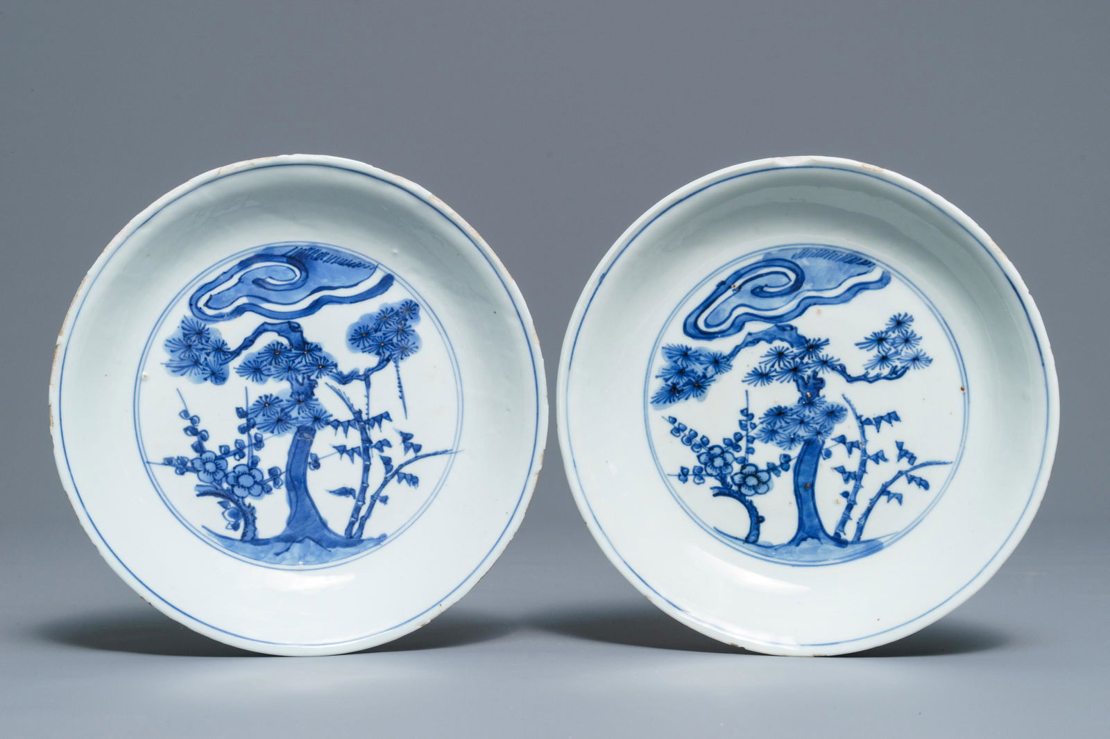 A pair of Chinese blue and white 'Three friends of: A pair of Chinese blue and white 'Three friends of winter' plates, Chenghua mark, Wanli Dia.: 19 cmÂ Condition: (UV-checked)- Both plates generally in good Condition, with typical irregularities an