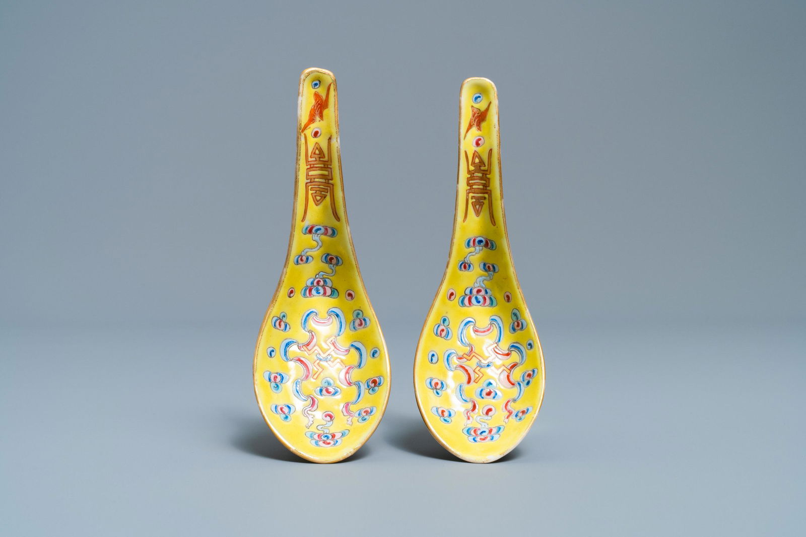 A pair of Chinese famille rose yellow-ground spoons,: A pair of Chinese famille rose yellow-ground spoons, Guangxu mark and of the period L.: 13 cm Provenance: A Belgian private collection, acquired between ca. 1970 and 2000.