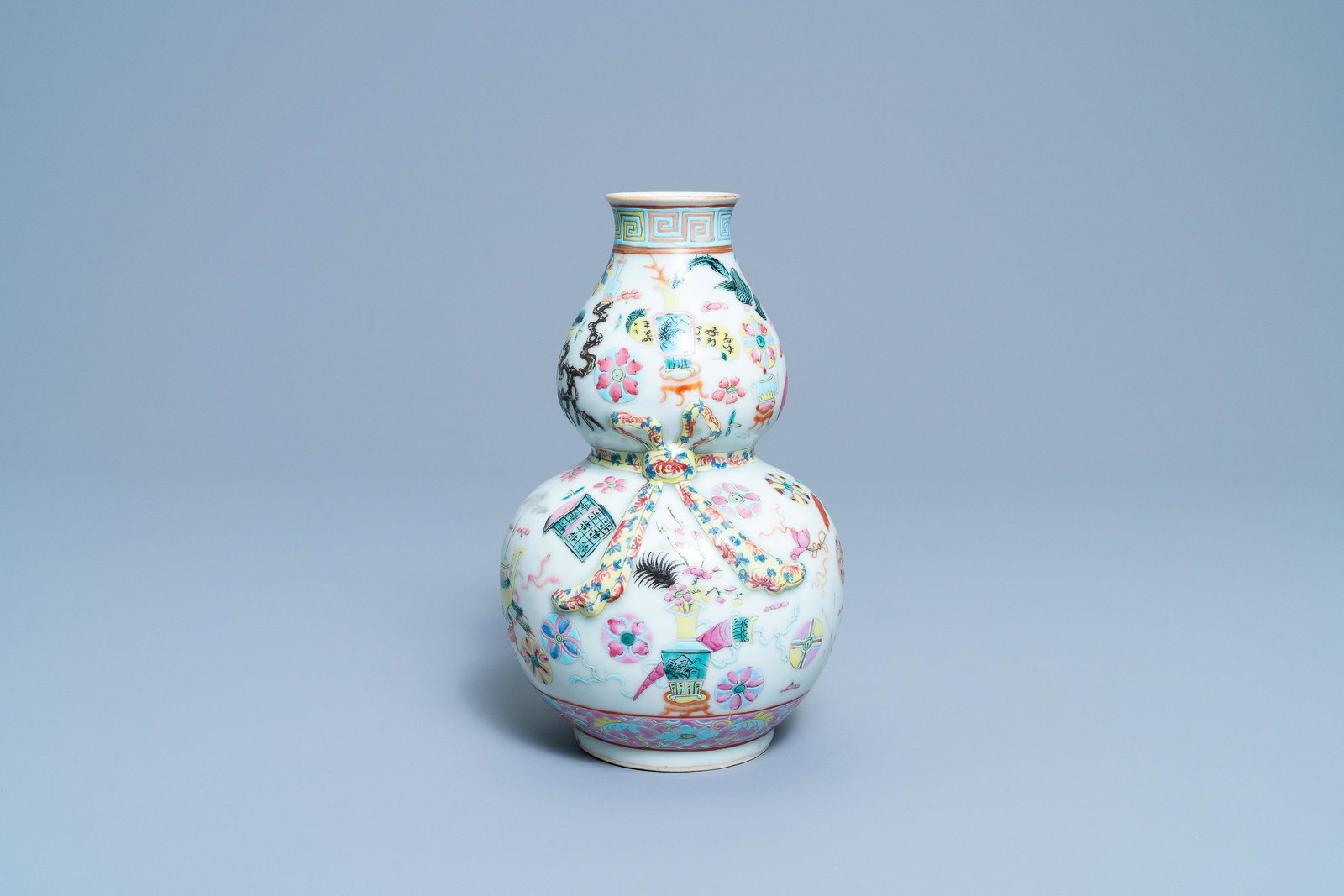 A Chinese famille rose double gourd 'antiquities' vase,: A Chinese famille rose double gourd 'antiquities' vase, 19th C. H.: 23 cm
