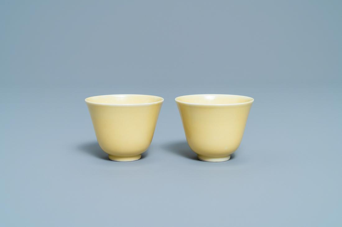 A pair of Chinese monochrome yellow wine cups, Kangxi: A pair of Chinese monochrome yellow wine cups, Kangxi mark and of the period Dia.: 6,5 cm - H.: 5 cm Provenance: The collection of a French envoy in China in the first half of the 20th C.