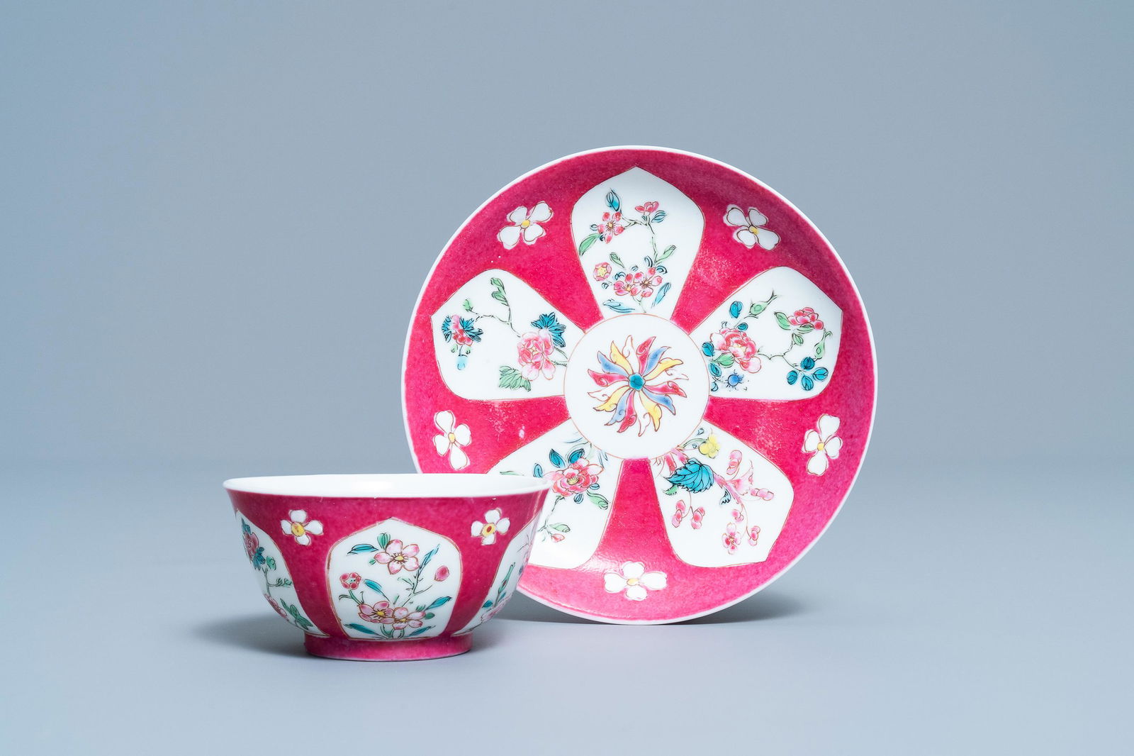 A Chinese famille rose ruby-ground cup and saucer,: A Chinese famille rose ruby-ground cup and saucer, Yongzheng Dia.: 11,5 cm (the saucer) Dia.: 7,5 cm - H.: 3,5 cm (the cup)
