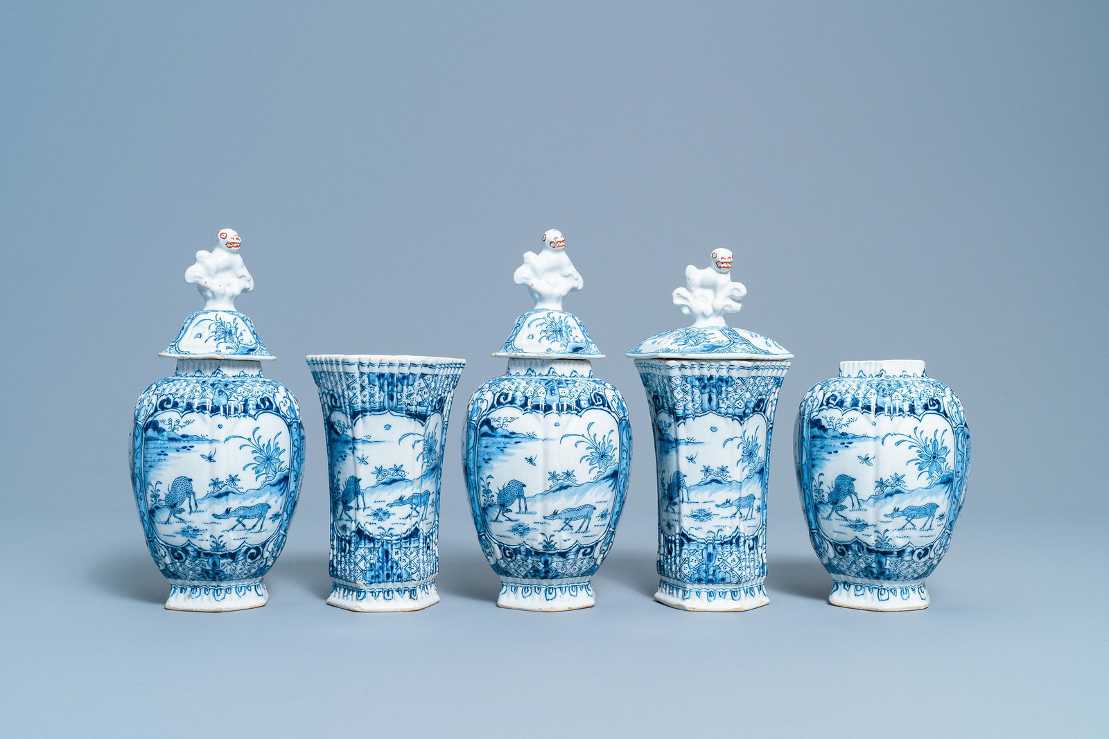 A Dutch Delft blue and white five-piece garniture with: A Dutch Delft blue and white five-piece garniture with chinoiserie design with deer, 18th C. H.: 29 cm (the tallest) Marked AIK on the base for Jacob van der Kool, the 'De Grieksche A' workshop, Delft