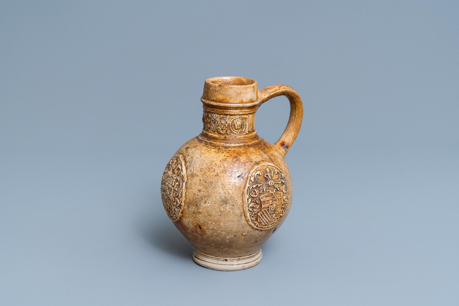 A stoneware jug with three armorial medallions, Raeren,: A stoneware jug with three armorial medallions, Raeren, ca. 1600 H.: 23 cm