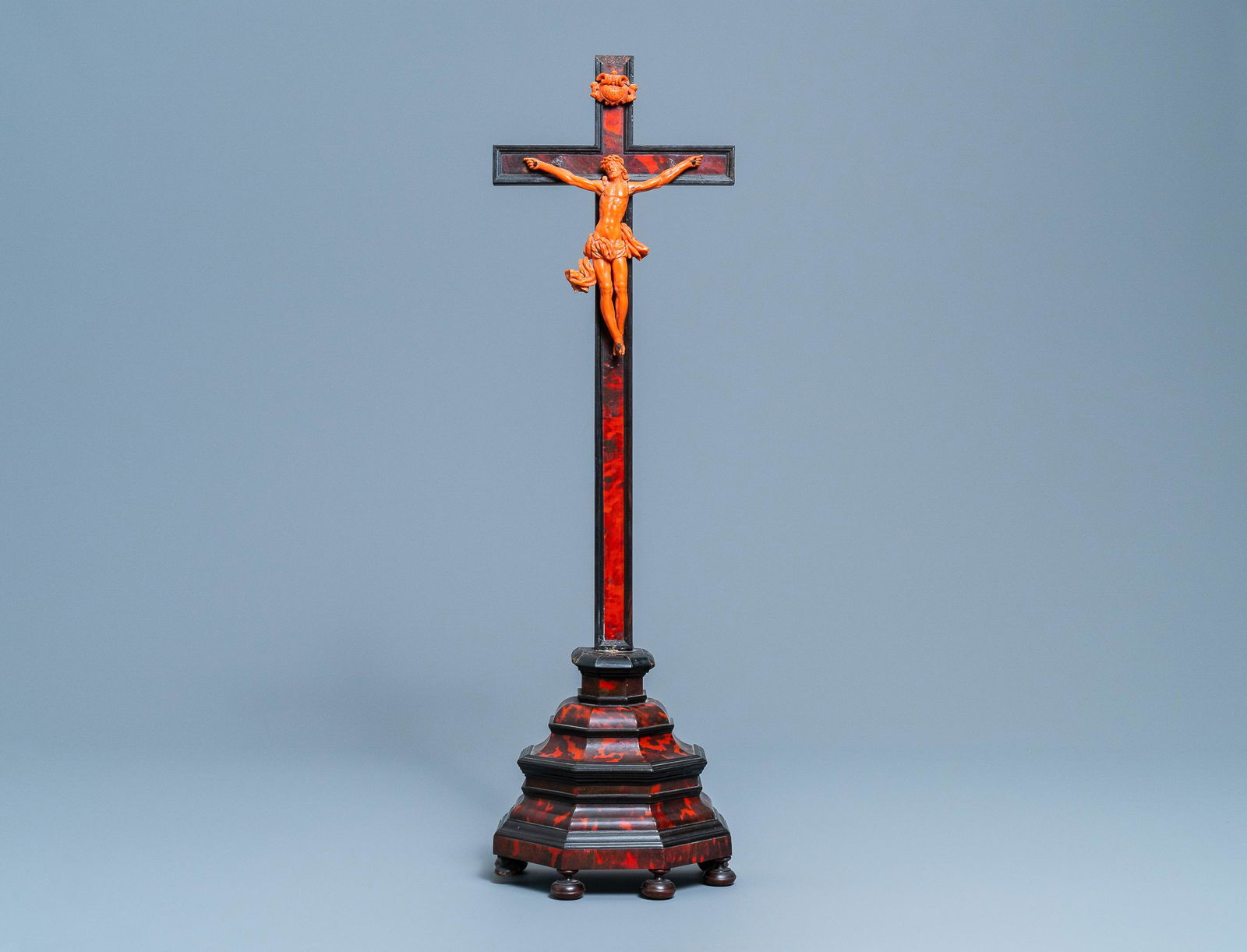 A crucifix with carved coral figure of Christ, Trapani,: A crucifix with carved coral figure of Christ, Trapani, Sicily, Italy, 17th C. H.: 70 cm (the crucifix on stand) Dim.: 17 x 15 cm (the figure of Christ)