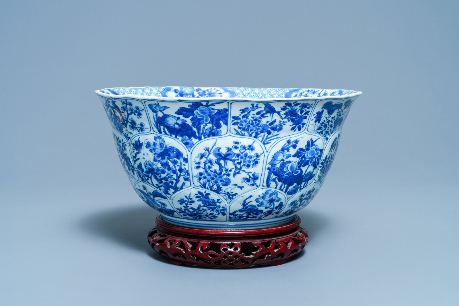 A large Chinese blue and white bowl with floral panels,: Full title: A large Chinese blue and white bowl with floral panels, Kangxi Description: Dia.: 33,5 cm - H.: 16,5 cm
