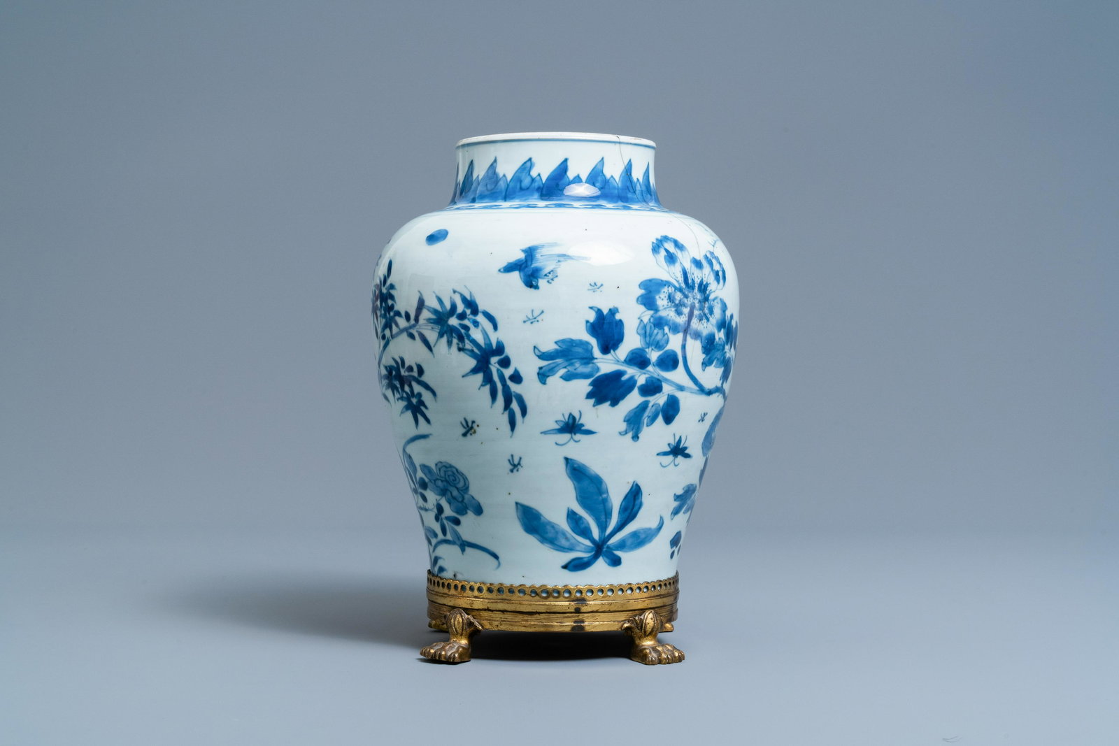 A Chinese blue and white vase on a gilt bronze foot,: Full title: A Chinese blue and white vase on a gilt bronze foot, Kangxi Description: H.: 32,5 cm (incl. stand) H.: 29 cm (the vase)