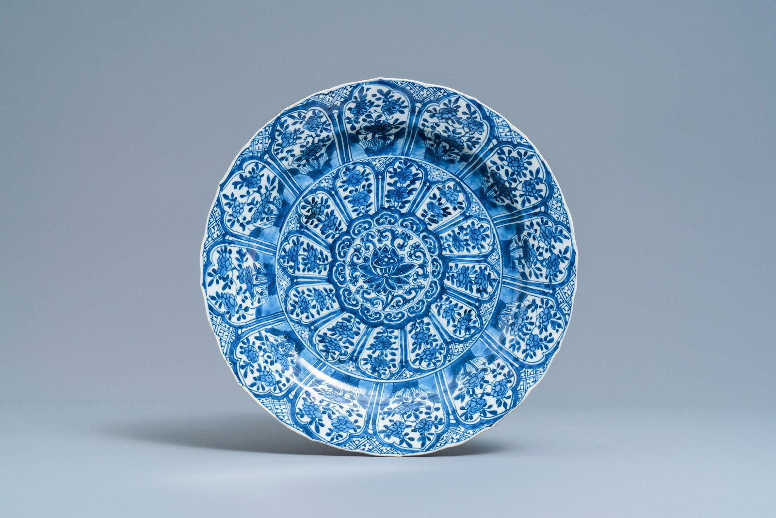 A Chinese blue and white charger with floral lotus: Full title: A Chinese blue and white charger with floral lotus design, Kangxi Description: Dia.: 37,5 cm