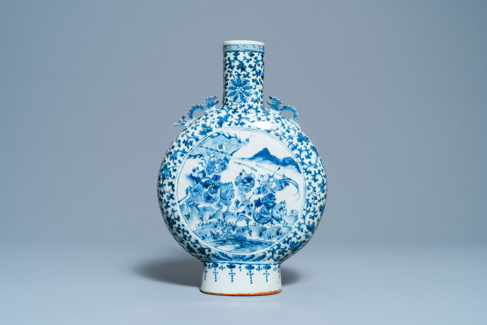 A Chinese blue and white 'moonflask' vase with warriors: Full title: A Chinese blue and white 'moonflask' vase with warriors on horseback, 19th C. Description: H.: 41 cm