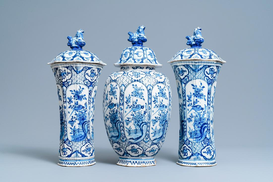 A Dutch Delft blue and white garniture of three vases: Full title: A Dutch Delft blue and white garniture of three vases and covers, 18th C. Description: H.: 50 cm