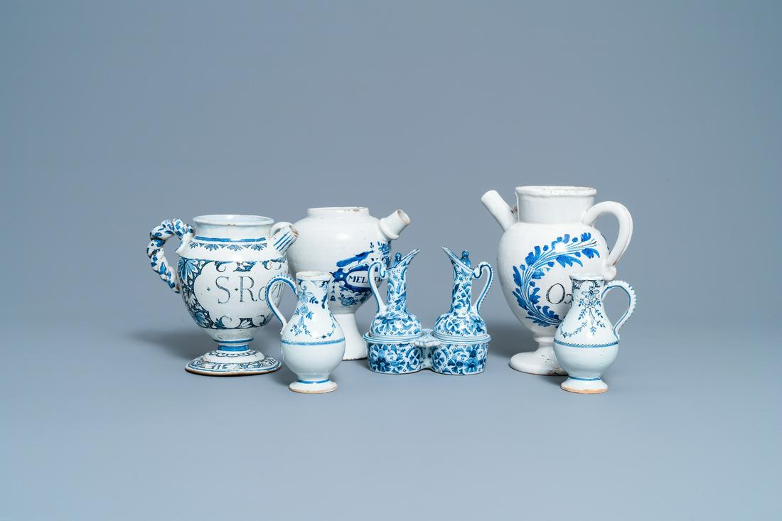 Three blue and white Dutch Delft, Nevers and Rouen wet: Full title: Three blue and white Dutch Delft, Nevers and Rouen wet drug jars and four jugs, 17/18th C. Description: H.: 24 cm (the tallest)Ê Please note that the pair of jugs on stand is of late 19th
