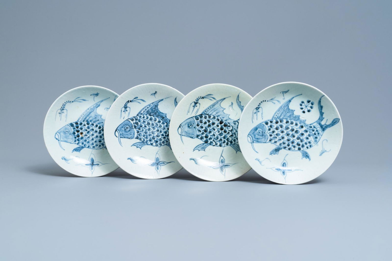 Four Chinese blue and white 'carps and shrimps' dishes,: Full title: Four Chinese blue and white 'carps and shrimps' dishes, Dehua, 18/19th C. Description: Dia.: 25,5 cm