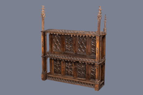 A carved oak shelf with pinnacles and stylised flowers: Full title: A carved oak shelf with pinnacles and stylised flowers and carved panels, 15th C. and later Description: Dim.: 149,5 x 122,5 x 34 cm Provenance: - The Davioud-Larminet collection,