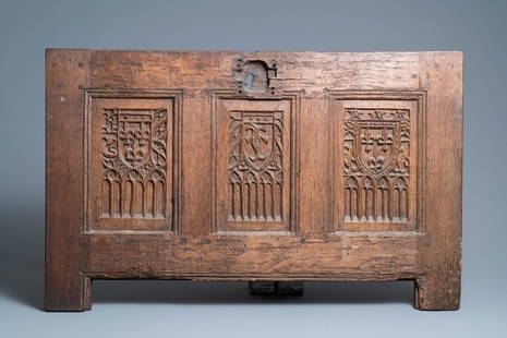 A carved oak front panel of a coffer with the arms of: Full title: A carved oak front panel of a coffer with the arms of France and the Dauphin, France, 2nd half 15th C. Description: Dim.: 100 x 62 cm Provenance: - The Davioud-Larminet collection,