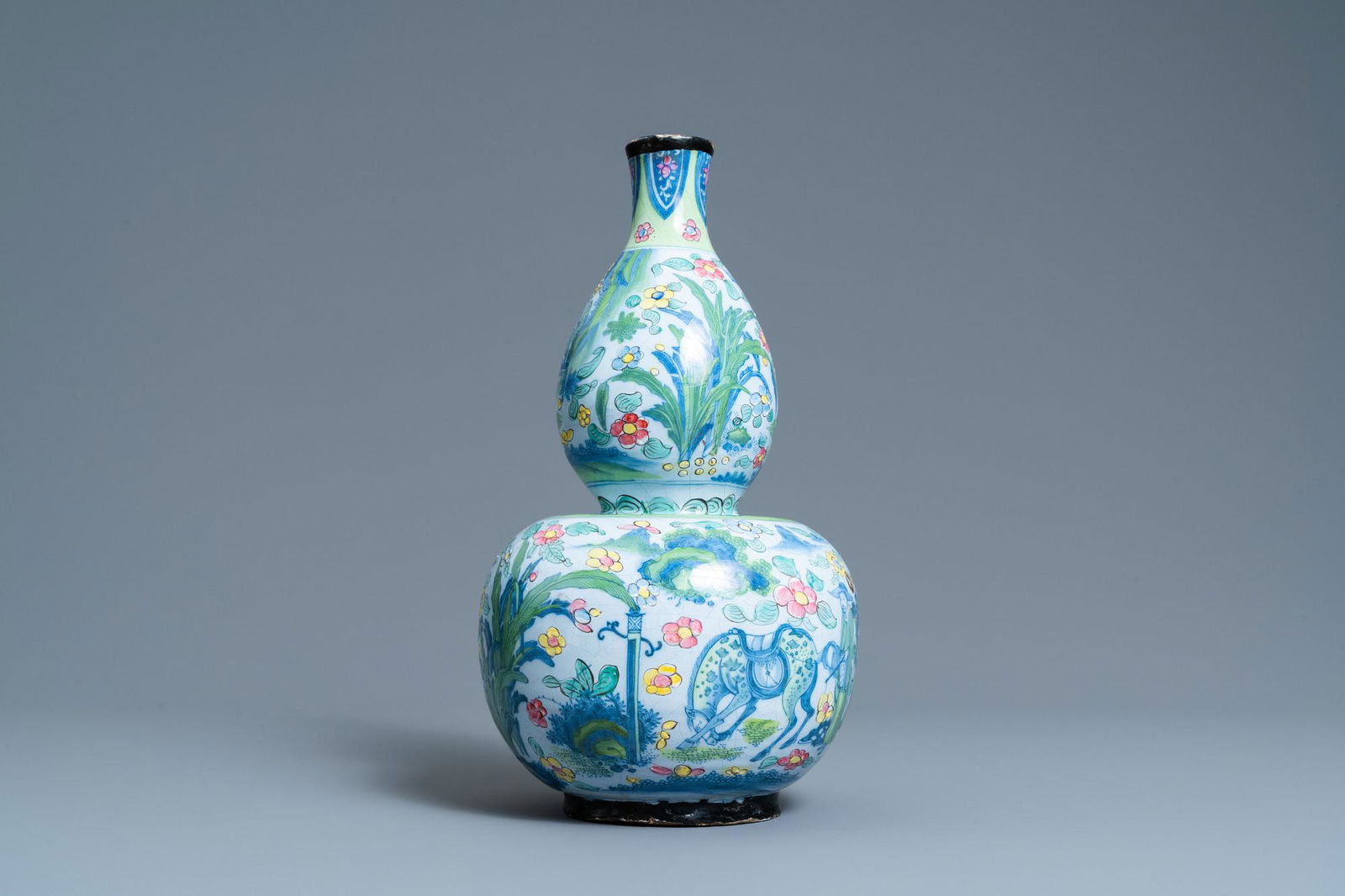 A clobbered Dutch Delft blue and white chinoiserie vase: Full title: A clobbered Dutch Delft blue and white chinoiserie vase with a pseudo-Chinese mark, ca. 1700 Description: H.: 35,5 cm Provenance: With a label for J. Zeberg, antiques dealer, Antwerp. Cond