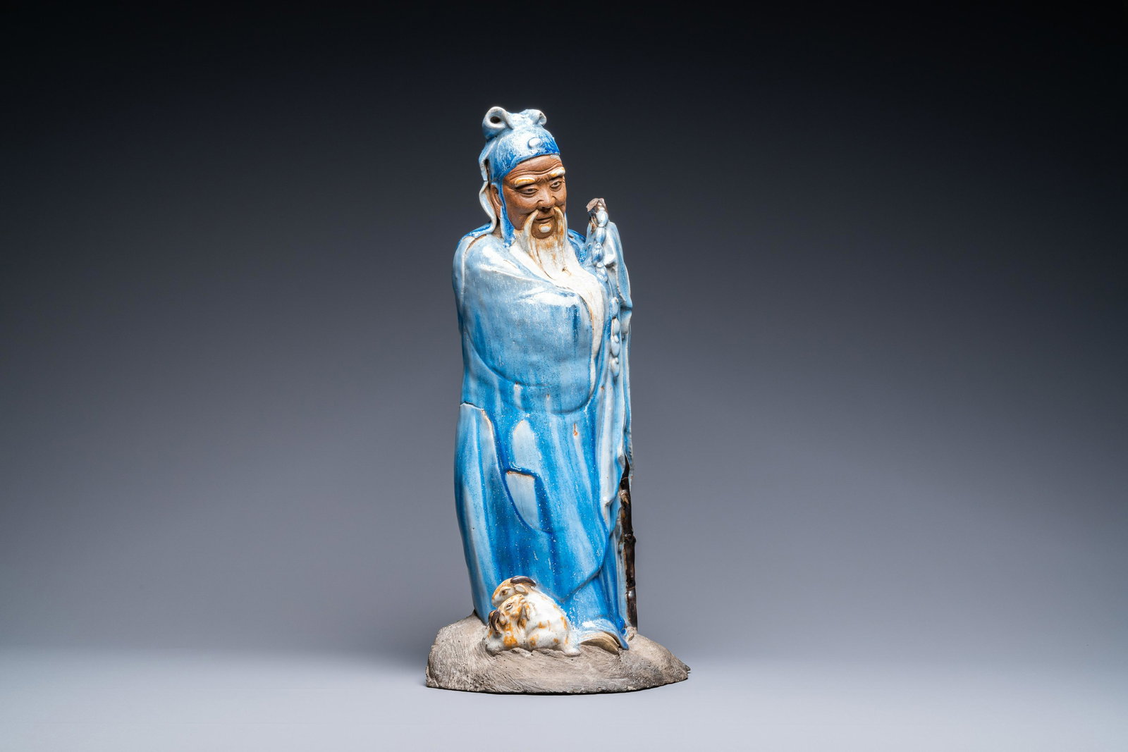 A large Chinese blue-glazed Shiwan pottery 'immortal': Full title: A large Chinese blue-glazed Shiwan pottery 'immortal' figure, 19th C. Description: H.: 58 cm The absence of a condition report does not imply that a lot is in perfect condition. Please con