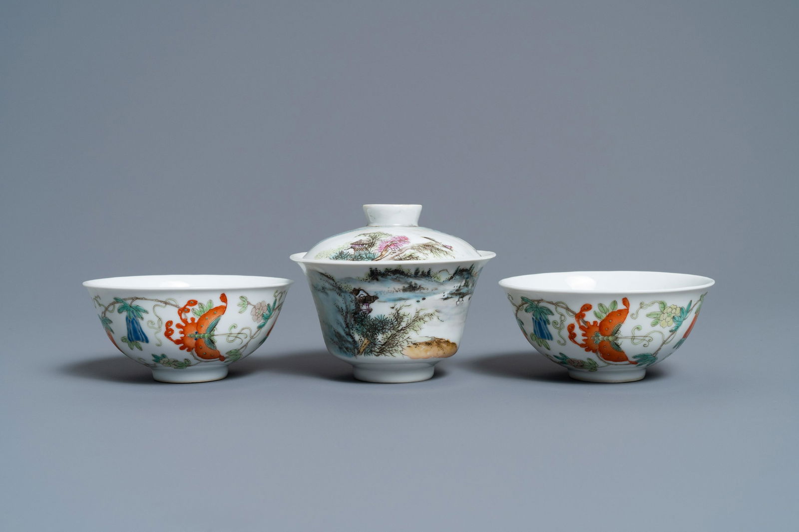A Chinese famille rose bowl and cover and two: Full title: A Chinese famille rose bowl and cover and two 'butterfly' bowls, Jingdezhen mark, Republic Description: Dia.: 10,5 cm - H.: 9 cm (the bowl and cover) The absence of a condition report does
