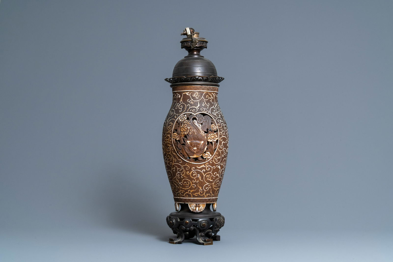 A Chinese reticulated biscuit 'Buddhist lions' vase: Full title: A Chinese reticulated biscuit 'Buddhist lions' vase mounted as a lamp, 19th C. Description: H.: 65,5 cm (the whole) The absence of a condition report does not imply that a lot is in perfec