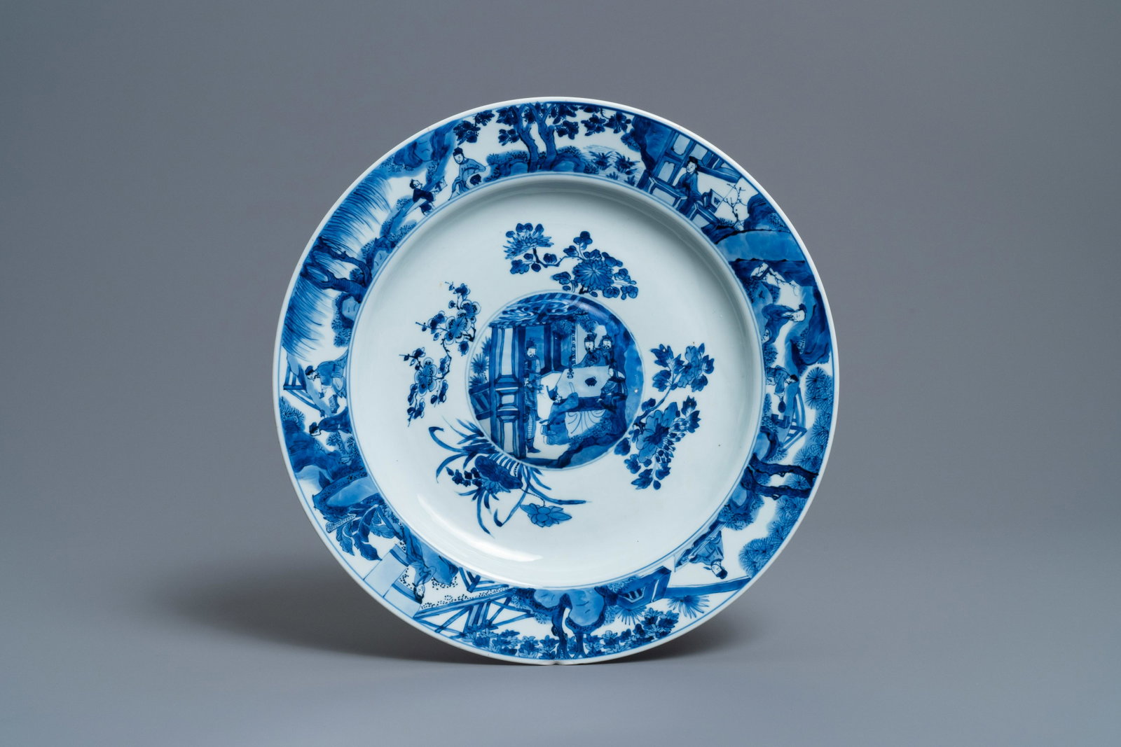A Chinese blue and white dish with raised central: Full title: A Chinese blue and white dish with raised central medallion, Kangxi Description: Dia.: 39 cm The absence of a condition report does not imply that a lot is in perfect condition. Please con