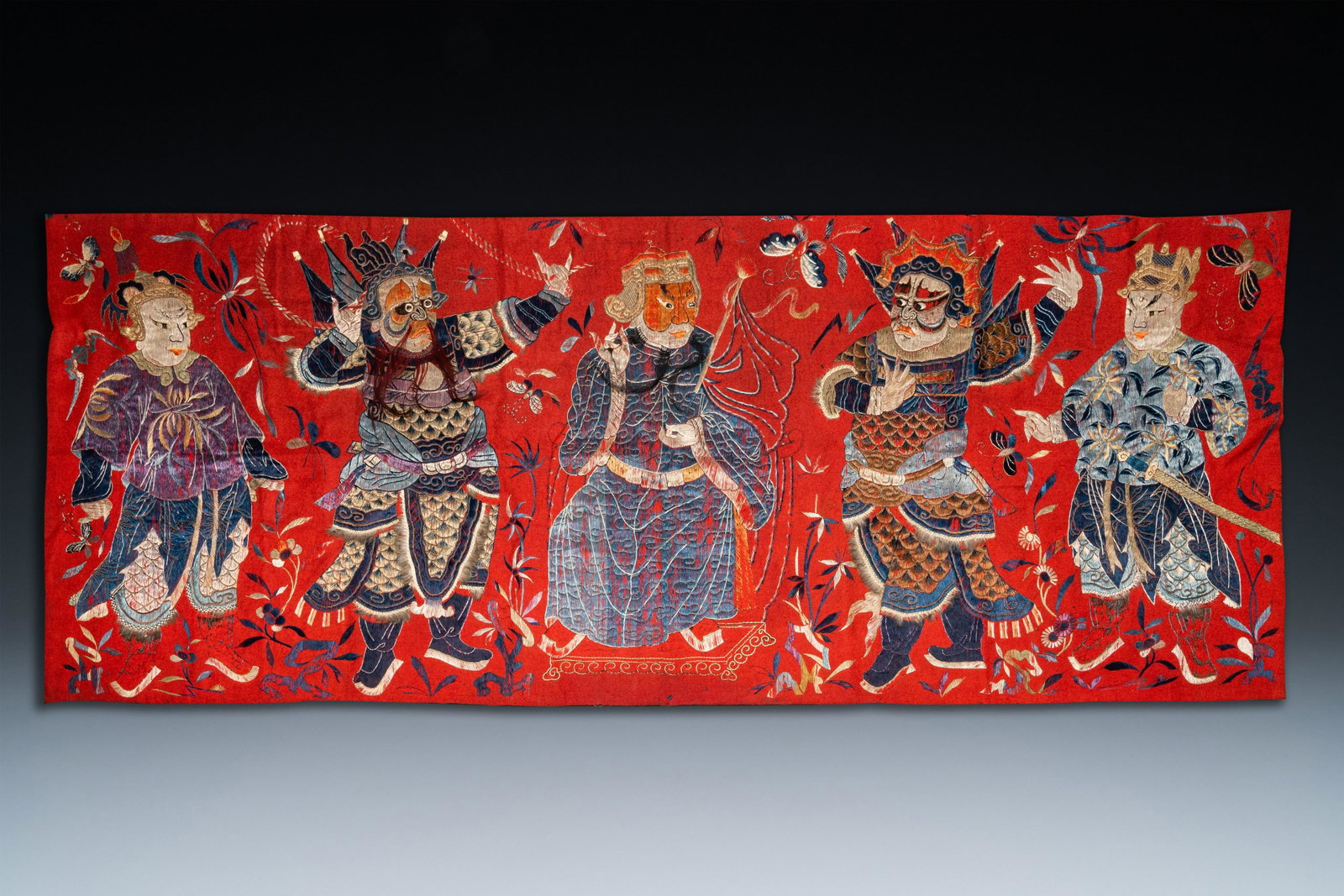 A Chinese red-ground felt cloth with silk embroidery of: Full title: A Chinese red-ground felt cloth with silk embroidery of figures, 19th C. Description: Dim.: 187 x 73 cm The absence of a condition report does not imply that a lot is in perfect condition.