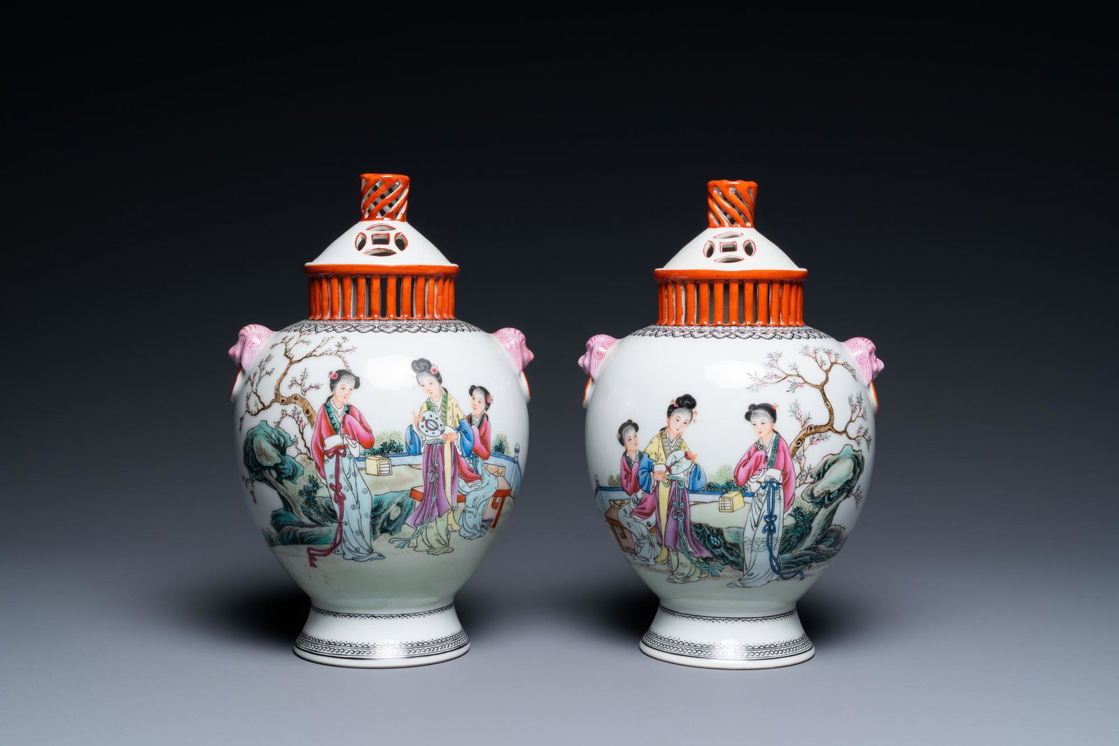 A pair of Chinese famille rose vases with reticulated covers, Qianlong mark, Republic: Full title: A pair of Chinese famille rose vases with reticulated covers, Qianlong mark, Republic Description: H.: 23 cm The absence of a condition report does not imply that a lot is in perfect condi
