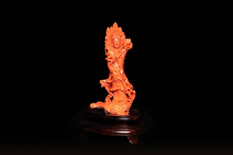 A large Chinese carved red coral 'Guanyin' figure, 19/20th C.: Full title: A large Chinese carved red coral 'Guanyin' figure, 19/20th C. Description: H.: 28,5 cm (incl. stand) H.: 24,5 cm (the coral) Weight: 718 grams excluding the wooden stand The absence