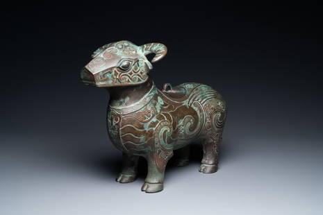 A Chinese ram-shaped silver-inlaid bronze 'xizun' vessel, Ming: Full title: A Chinese ram-shaped silver-inlaid bronze 'xizun' vessel, Ming Description: L.: 37,5 cm - H.: 30 cm The lid on the vessel is a modern cast. Provenance: - J.T.Tai & Company, New