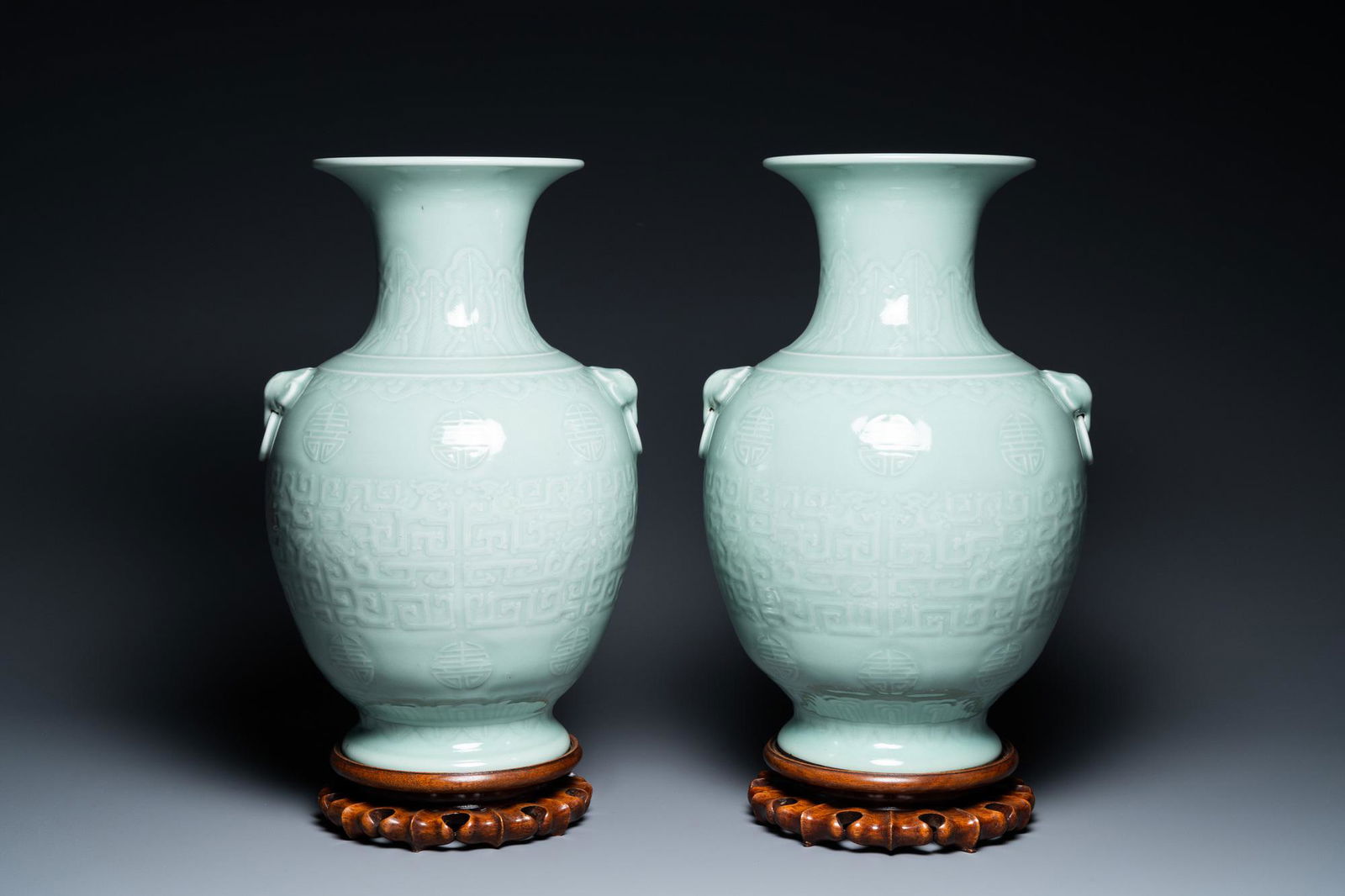 A pair of Chinese monochrome celadon vases with underglaze design on wooden stands, Qianlong mark, (1 of 9)