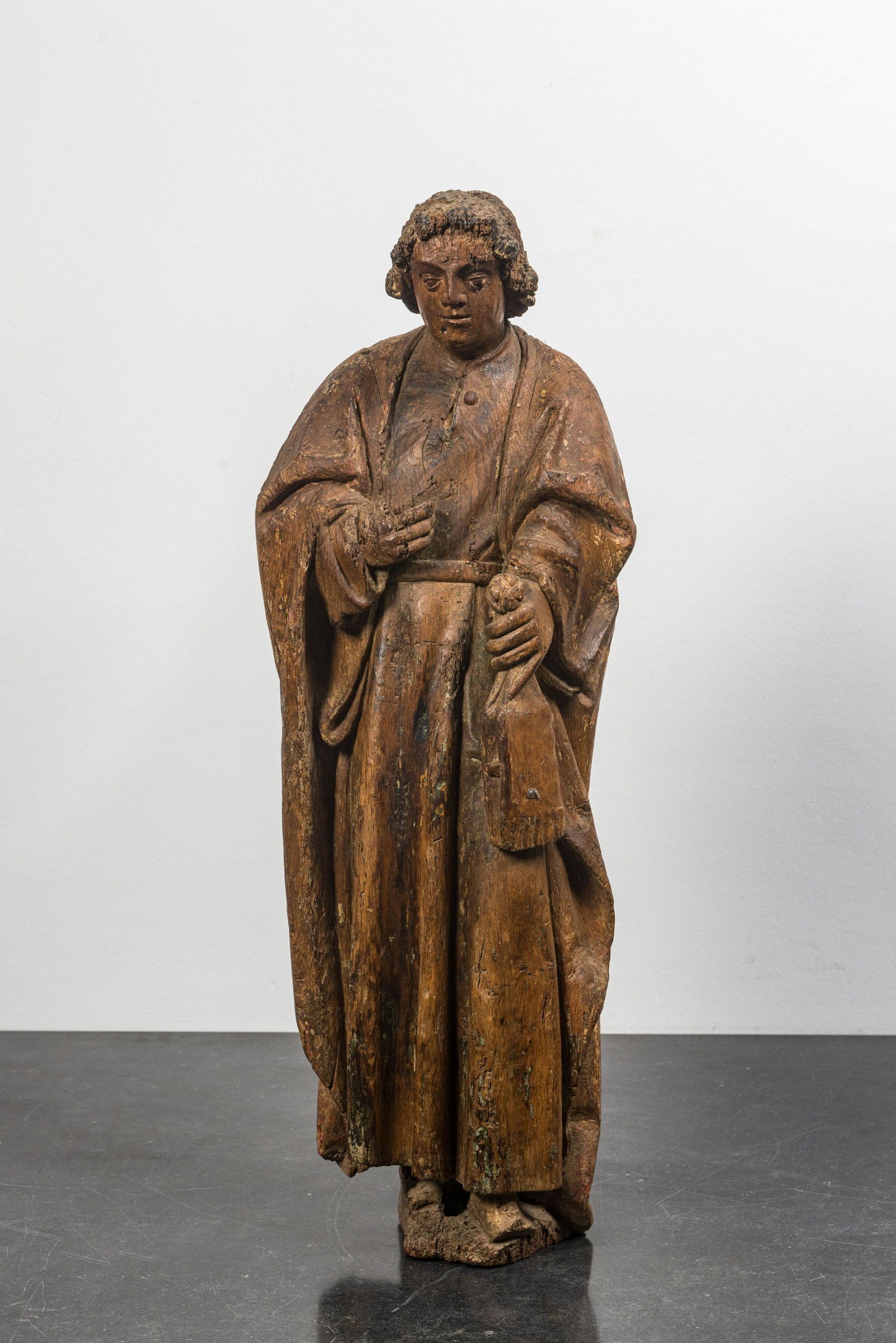 A Flemish oak figure of Saint John with traces of polychromy, 16th C. (1 of 3)