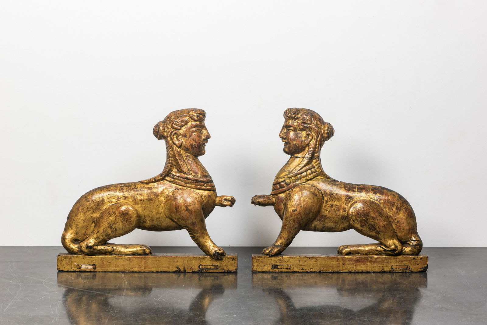 A pair of gilt wooden models of sphinx, France or Italy, 18th C.: Full title: A pair of gilt wooden models of sphinx, France or Italy, 18th C. Description: H 48 x L 52 cm