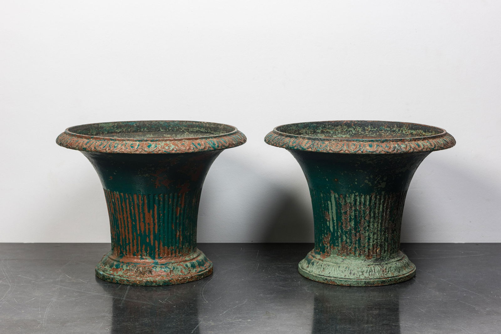 A pair of green-painted cast iron jardiniÃ¨res, 19th C. (1 of 2)