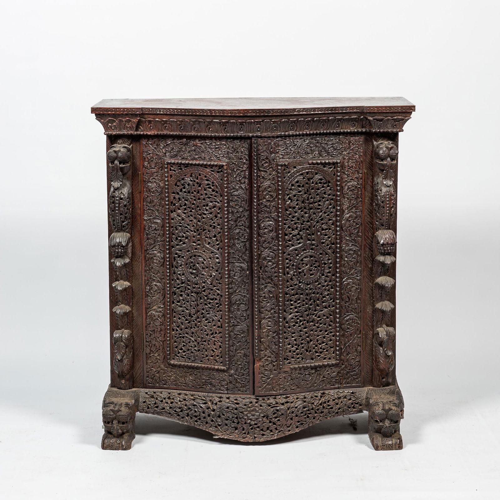 An Anglo-Indian colonial carved wooden two-door cabinet, 19th C. (1 of 3)