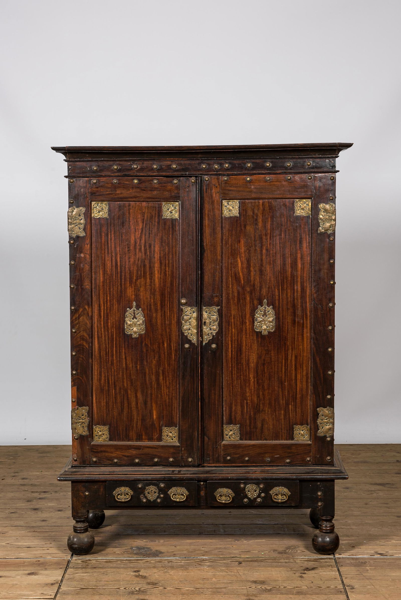 An English colonial brass mounted two-door cabinet, 19th C. (1 of 3)