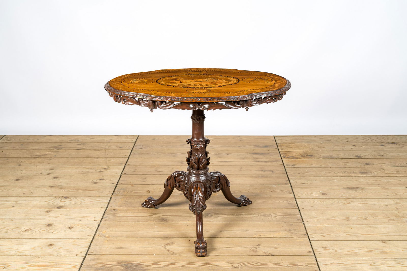 An Austrian or Swiss gueridon with marquetry design of flowers and animals, 19th C. (1 of 2)