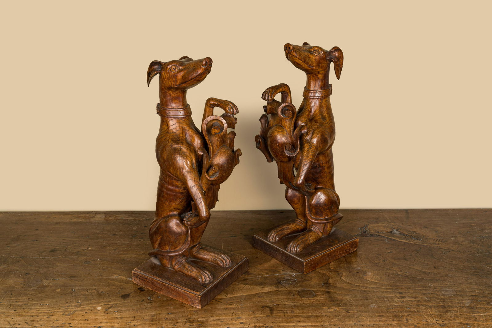 A pair of English wooden greyhounds with a shield, 19th C. (1 of 3)