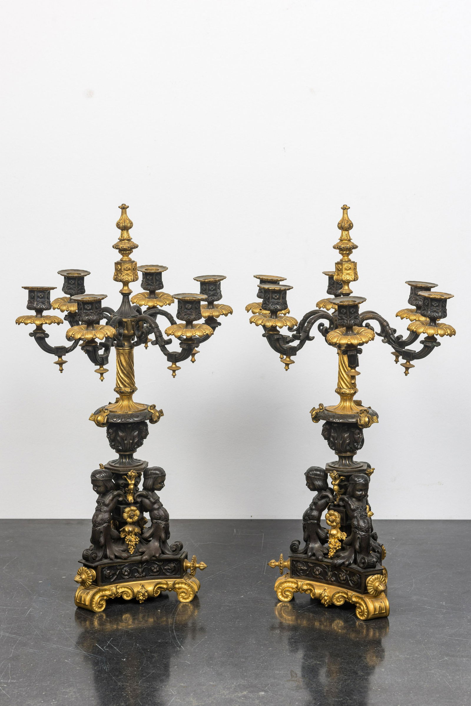 A pair of Franch partly gilt bronze 'atlants' candelabra, 19th C. (1 of 2)