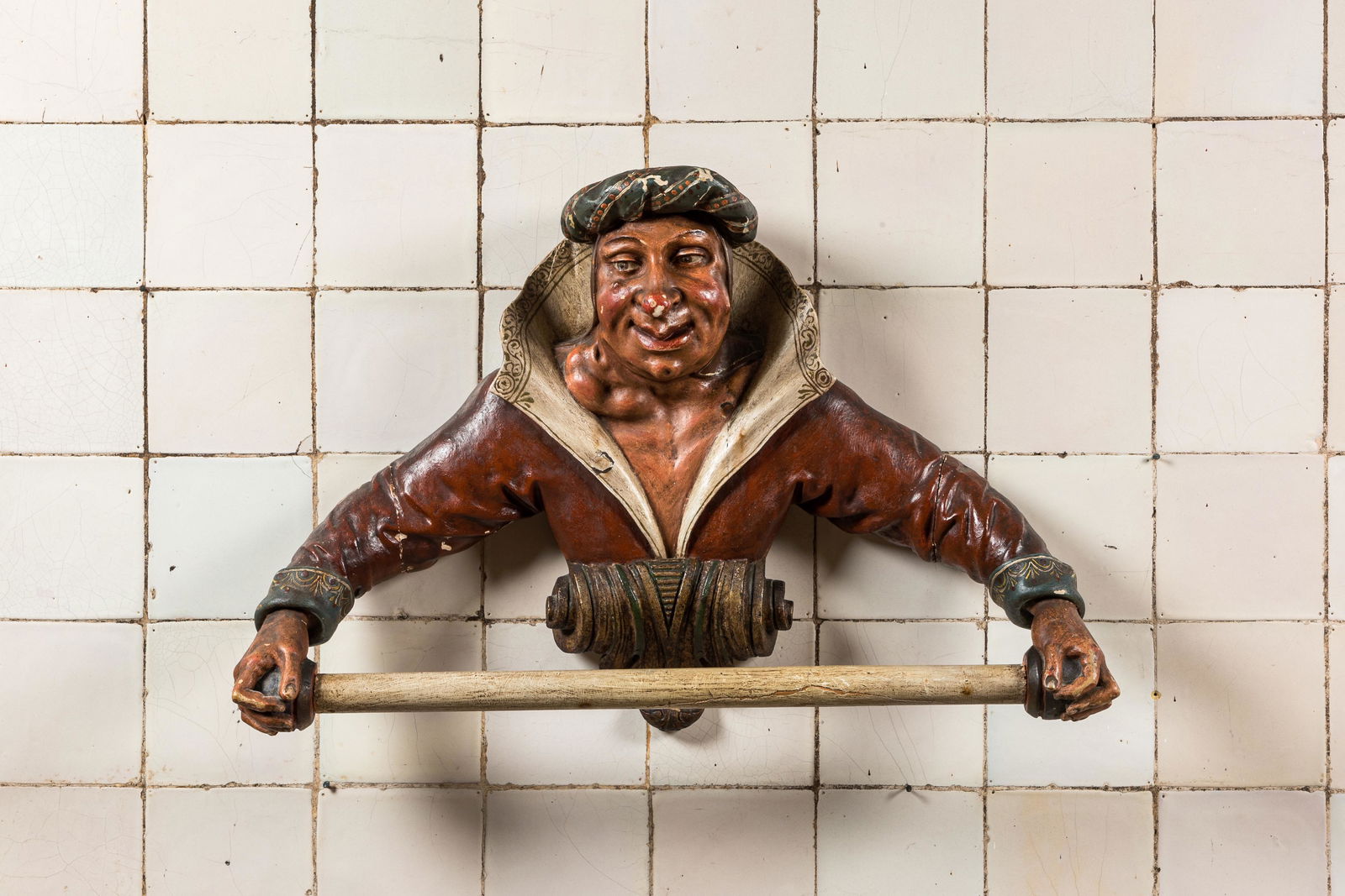 A rare polychromed wooden towel rack in the shape of a mischievous guy, 19th C. (1 of 2)