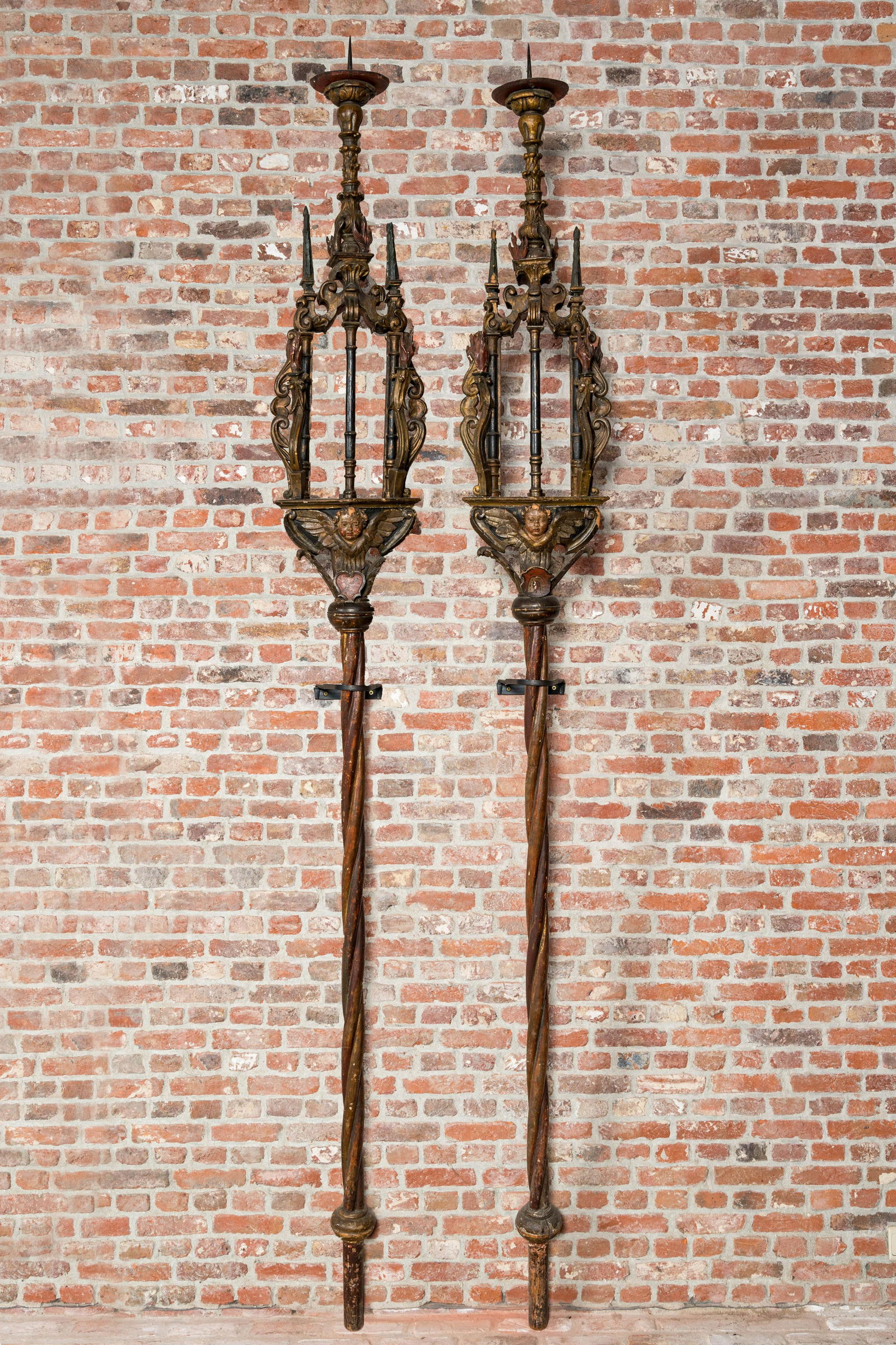 A pair of large polychromed and gilt processional torches with cherub heads, 18th C. (1 of 6)