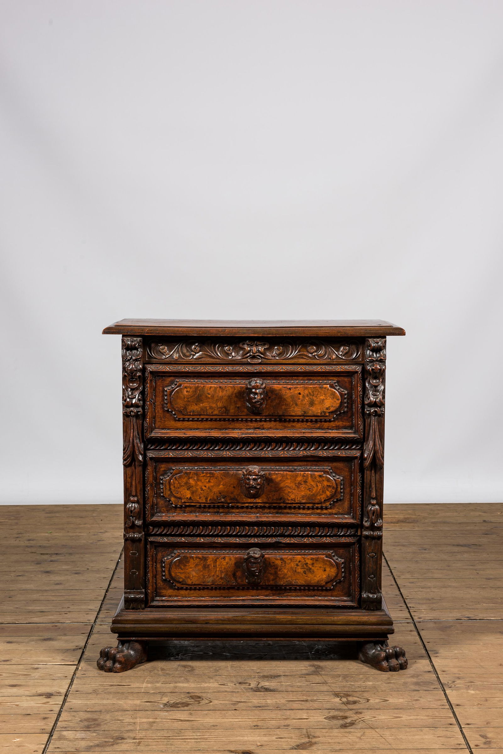 An Italian richly decorated walnut and burl wood chest of drawers with mascarons, 19th C. (1 of 3)